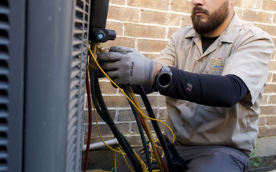 Technician working on an AC unit